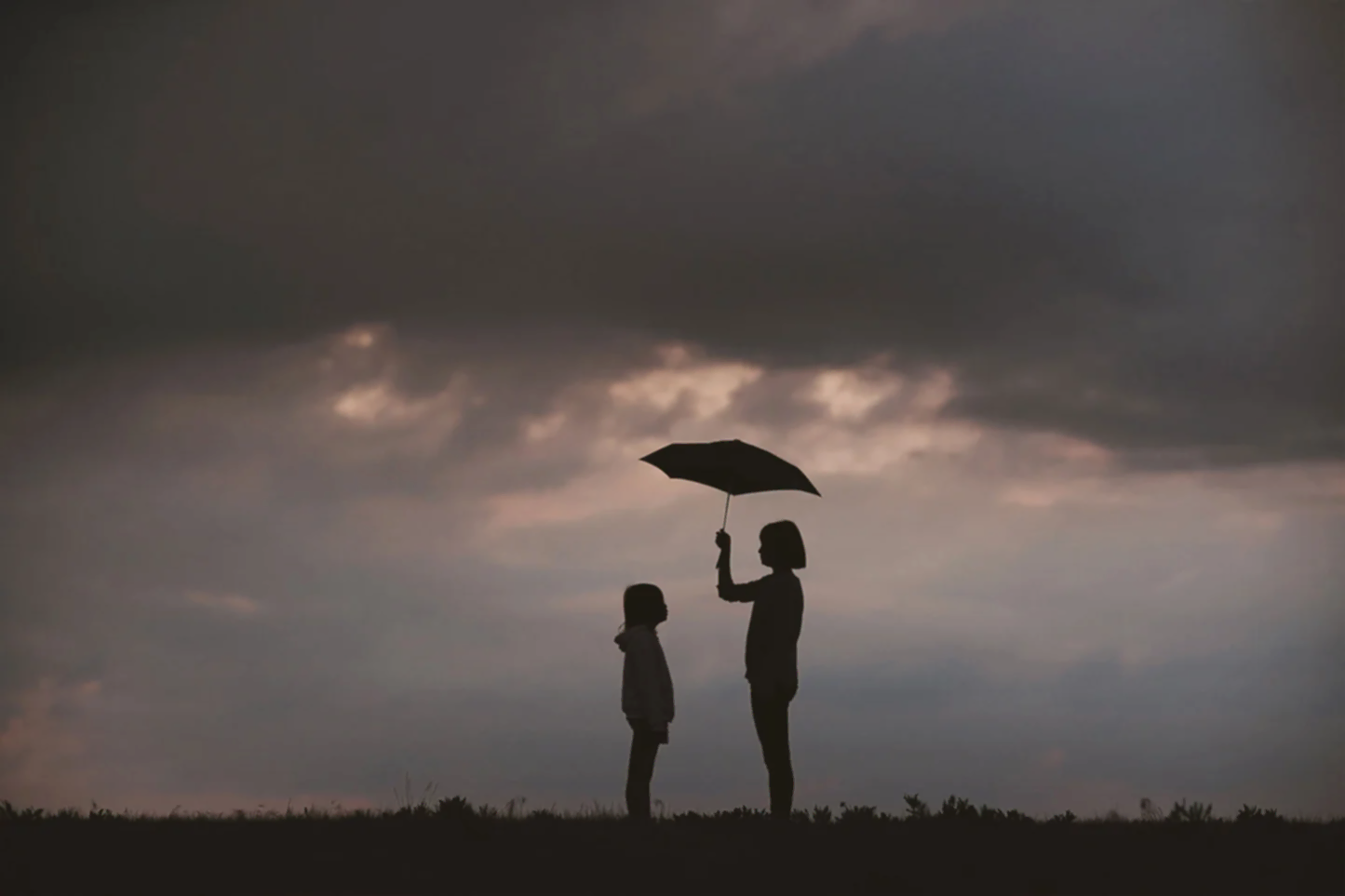 sisters with an umbrella